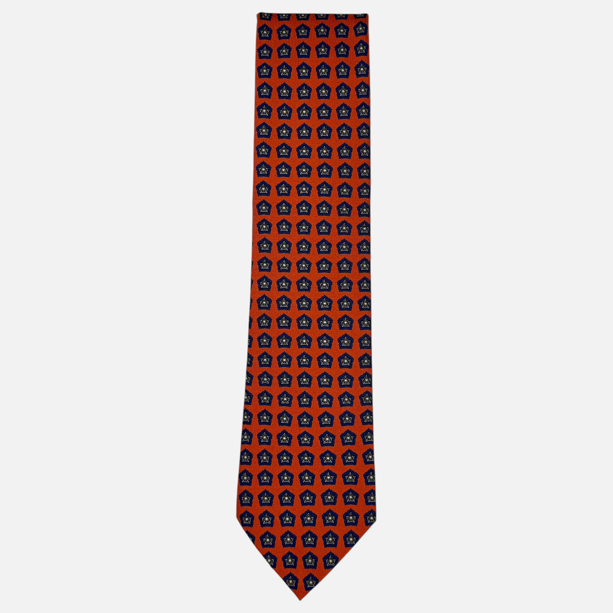 An orange neck tie with blue repeating star medallions.