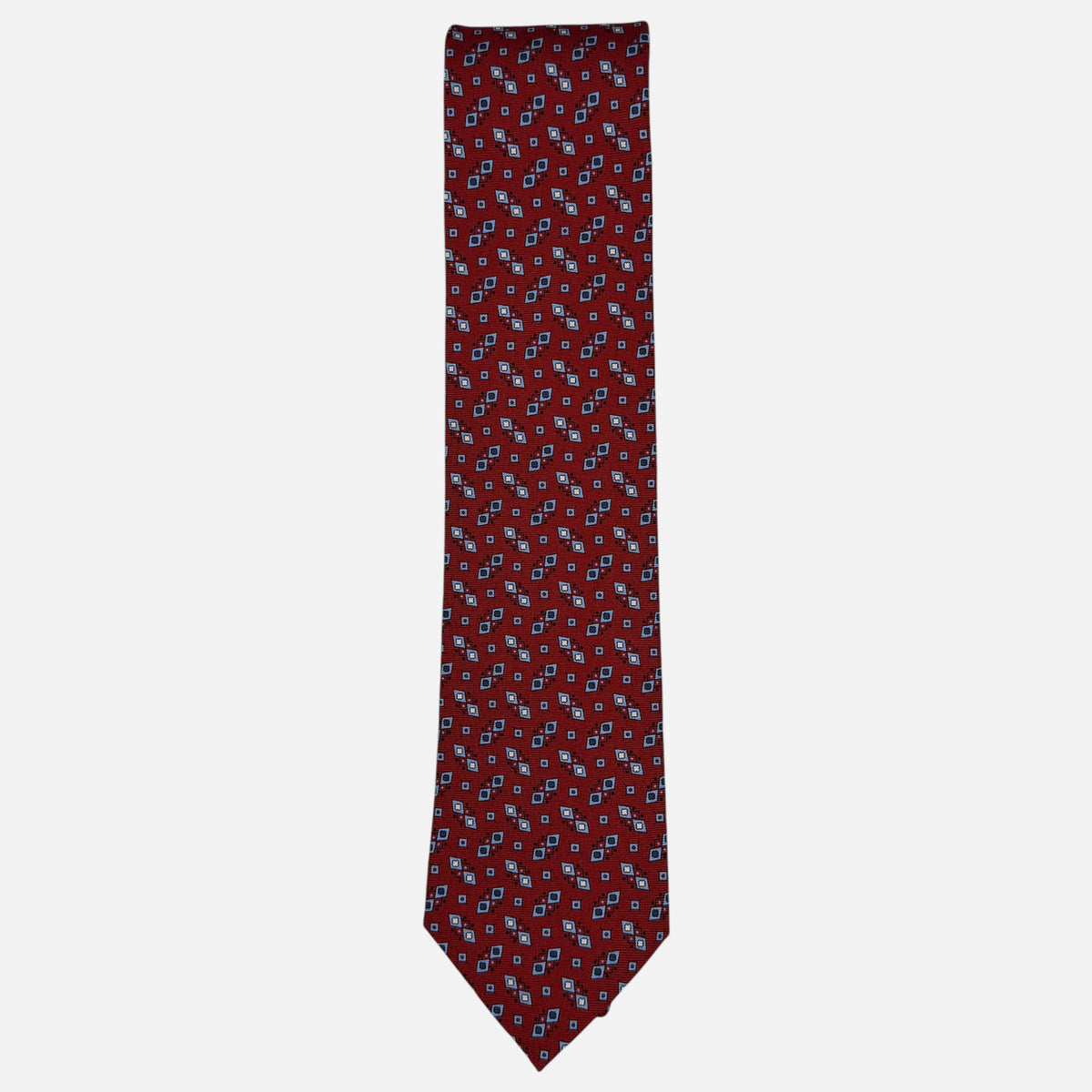 A classic red necktie with sky blue and navy geometric patterns.