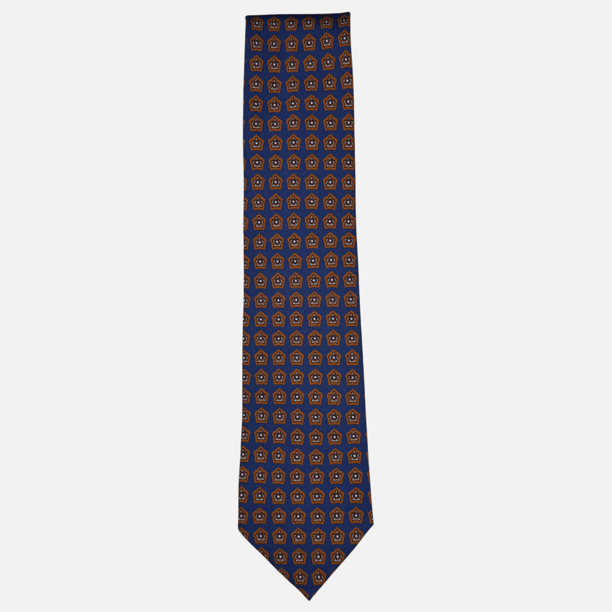 A royal blue necktie with deep rust star medallions repeating across the silk.