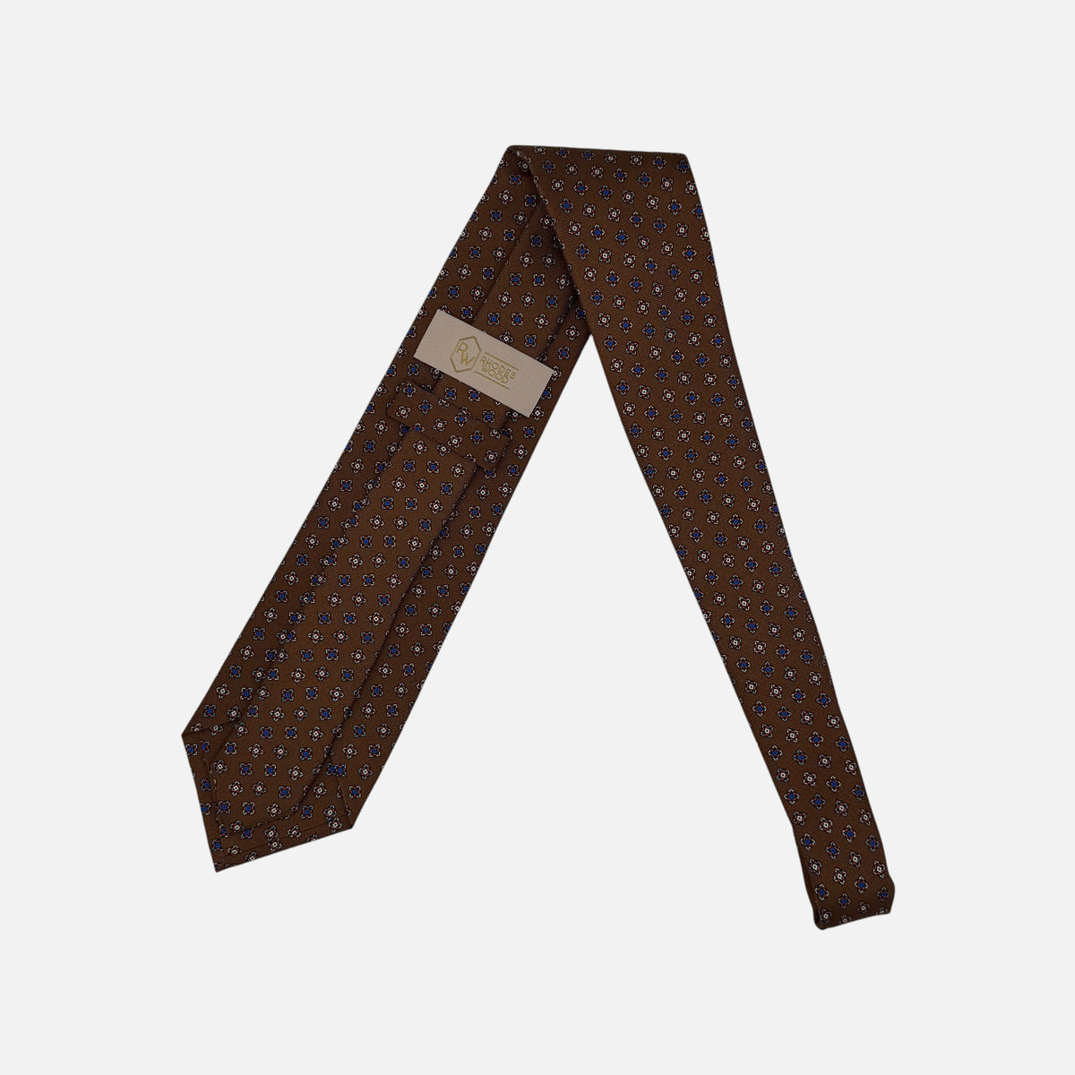 A chestnut coloured tie, with a medallion pattern. 