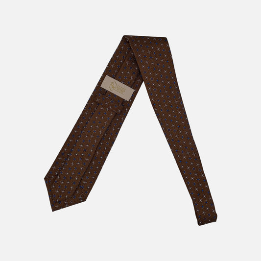 A chestnut coloured tie, with a medallion pattern. 