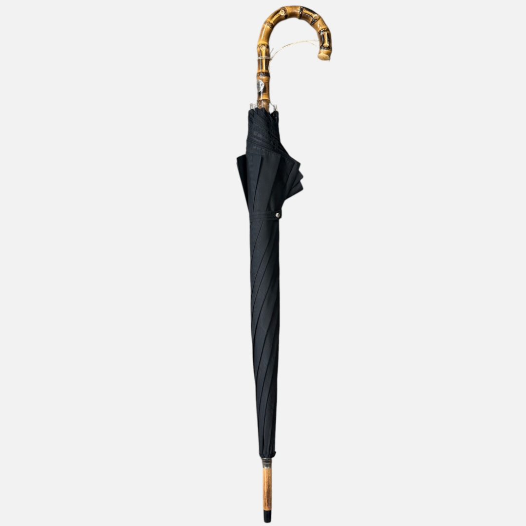 A black striped umbrella on a Wanghee handle