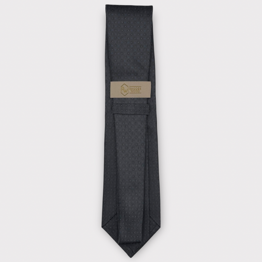 Classic silk necktie, printed in England, with a 9cm blade and 150cm length, laid flat against a plain background