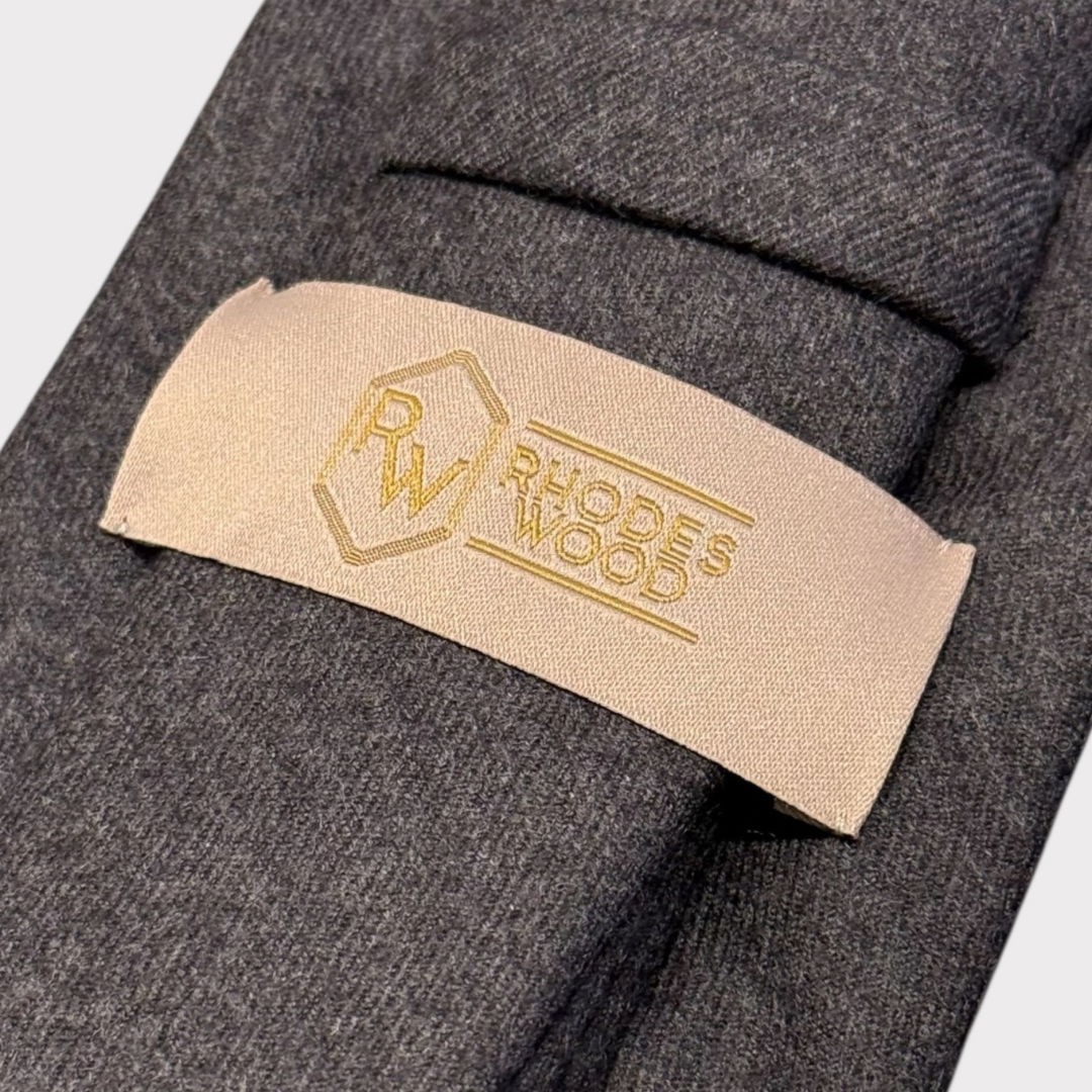 Close-up of a gray garment with a 'Rhodes Wood' label.