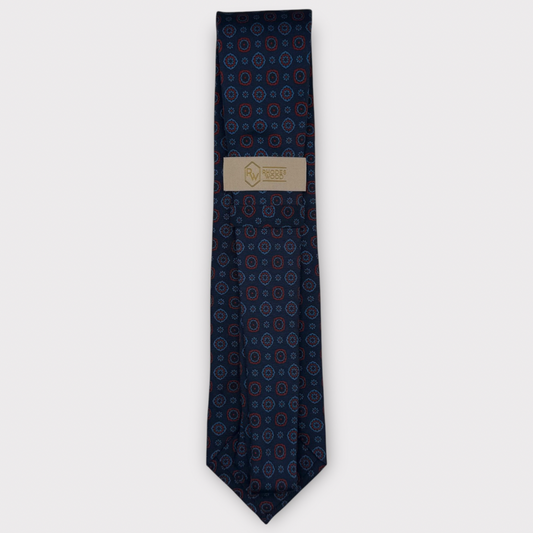 Classic silk necktie, printed in England, with a 9cm blade and 150cm length, laid flat against a plain background