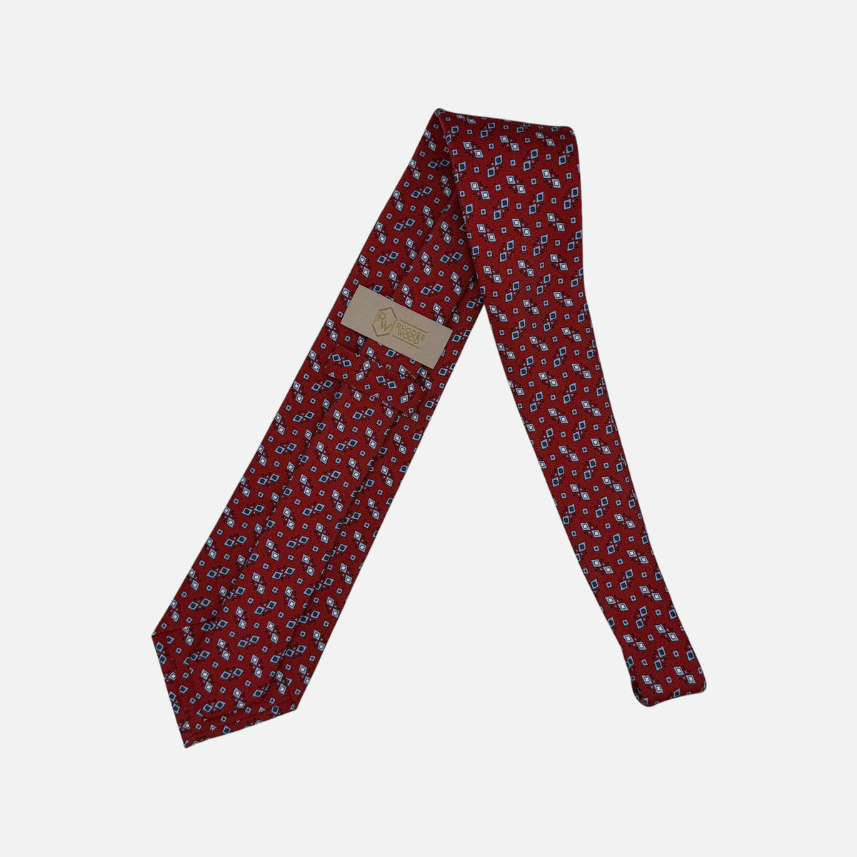 A classic red necktie with sky blue and navy geometric patterns.