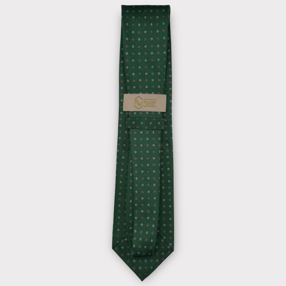 Classic silk necktie, printed in England, with a 9cm blade and 150cm length, laid flat against a plain background