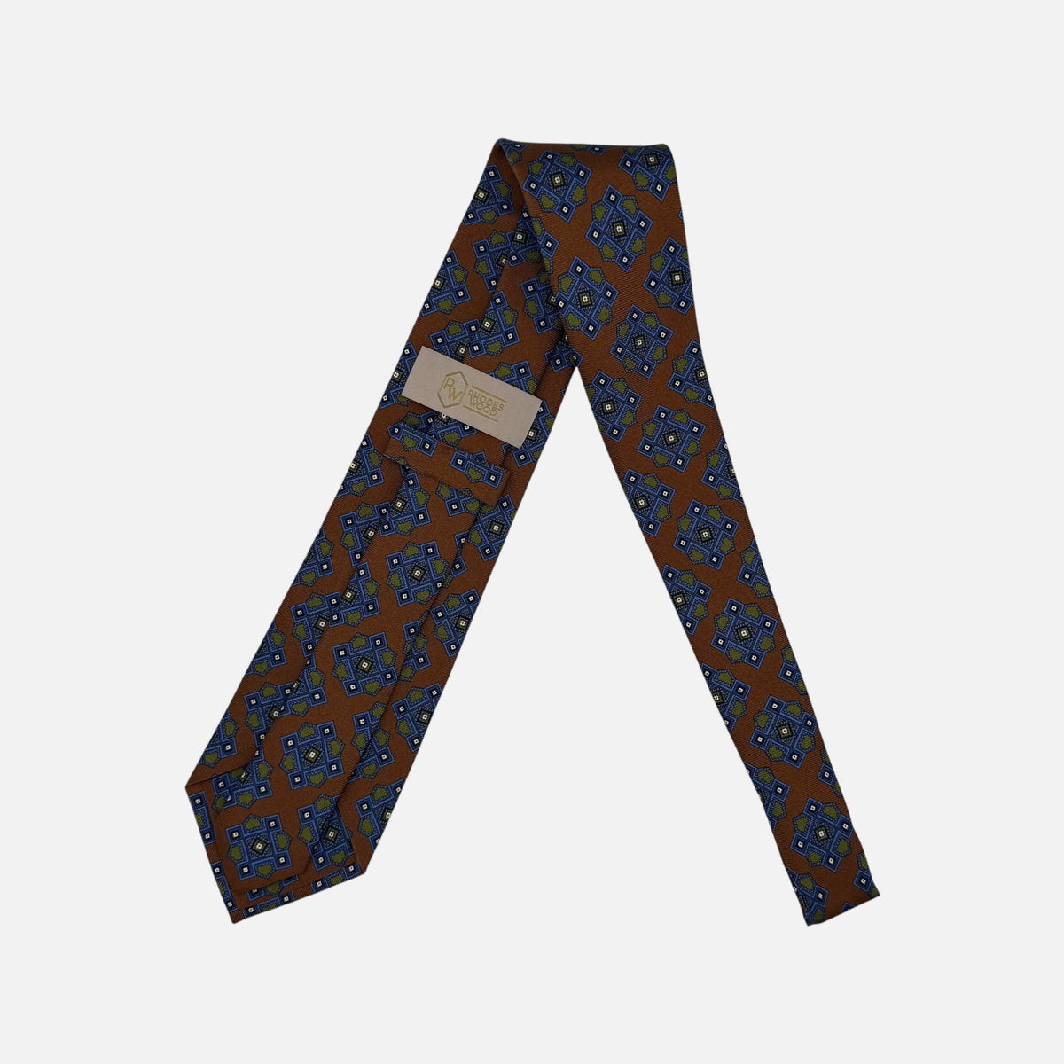 A Cognac neck tie with large blue and green medallion. 