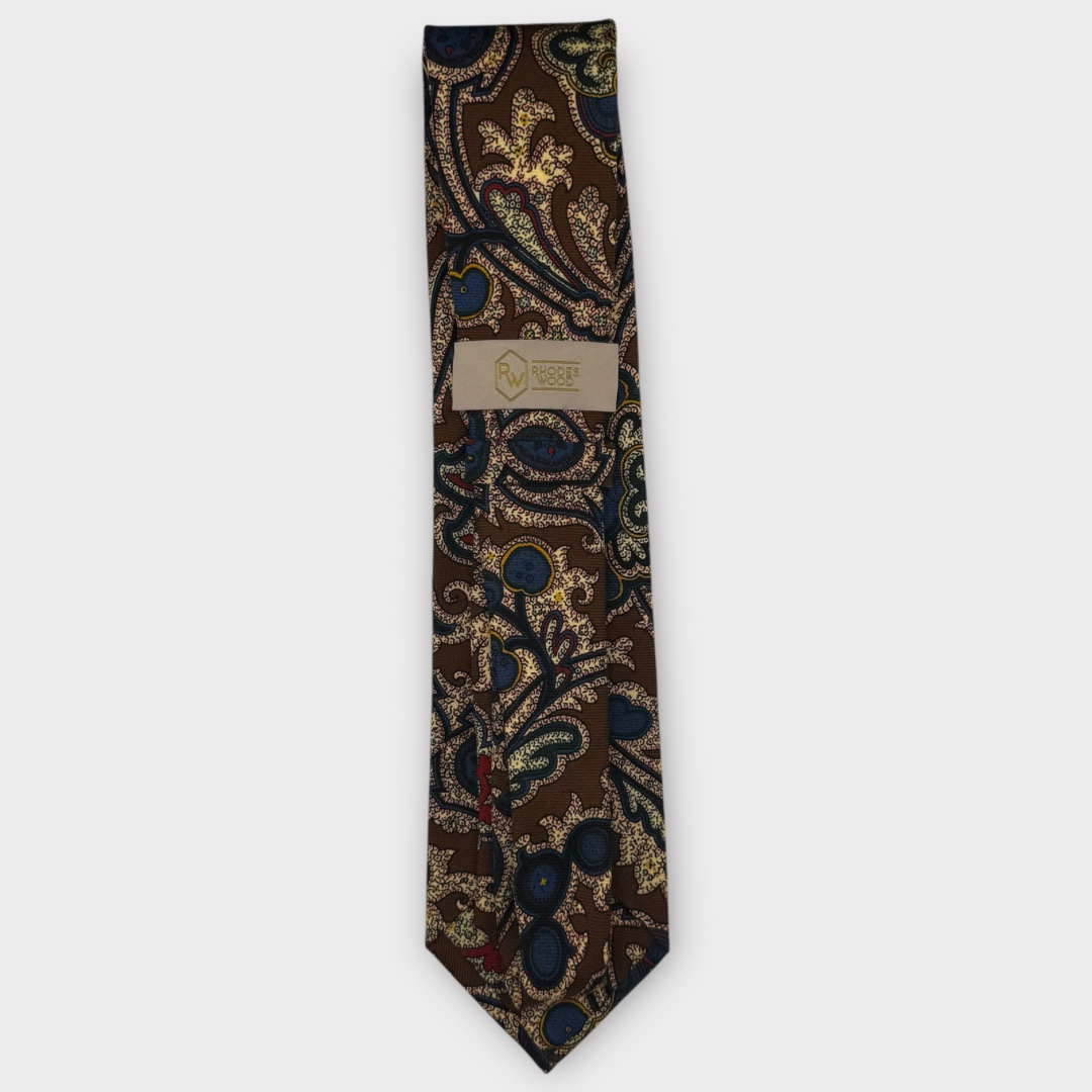 Classic silk necktie, printed in England, with a 9cm blade and 150cm length, laid flat against a plain background