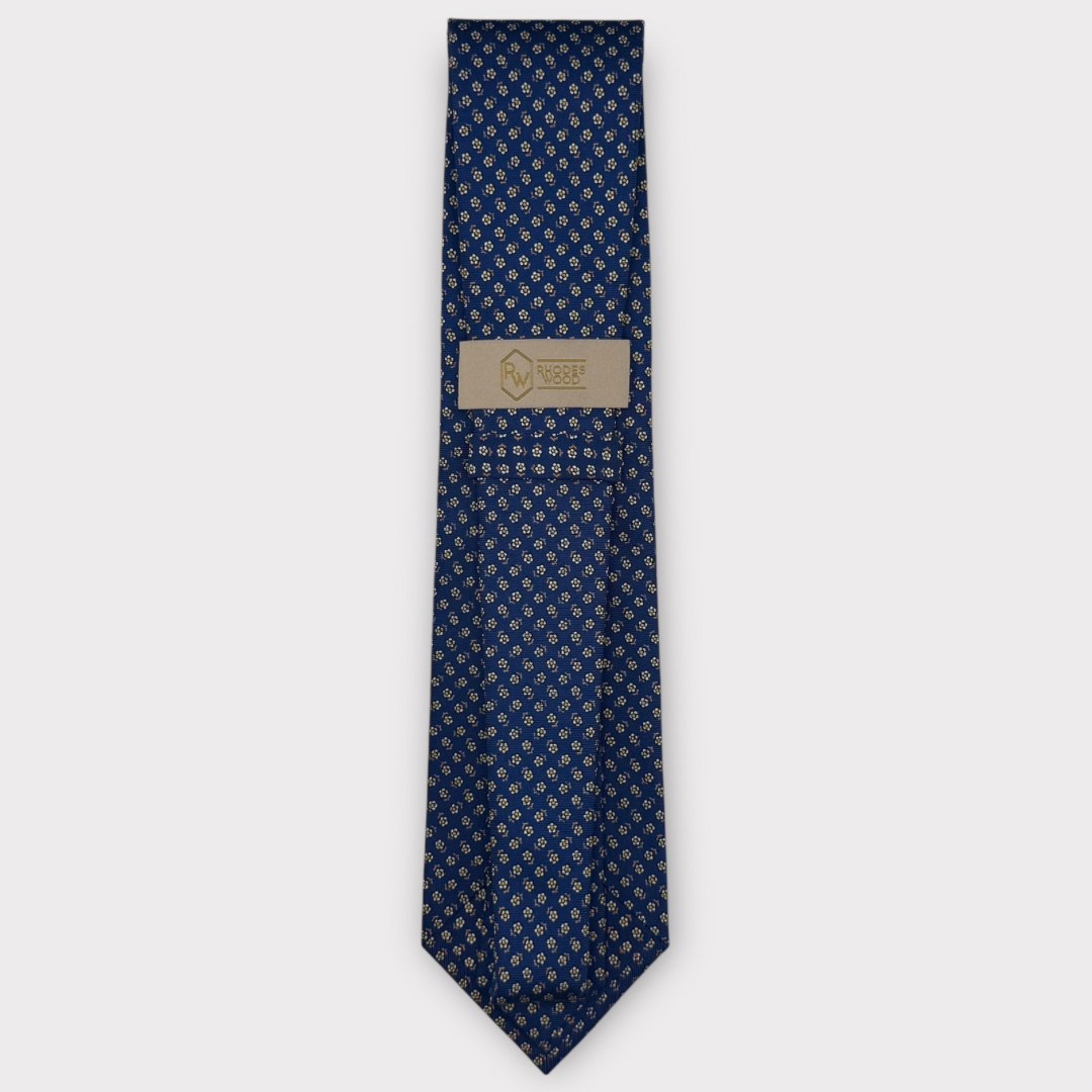 Classic silk necktie, printed in England, with a 9cm blade and 150cm length, laid flat against a plain background