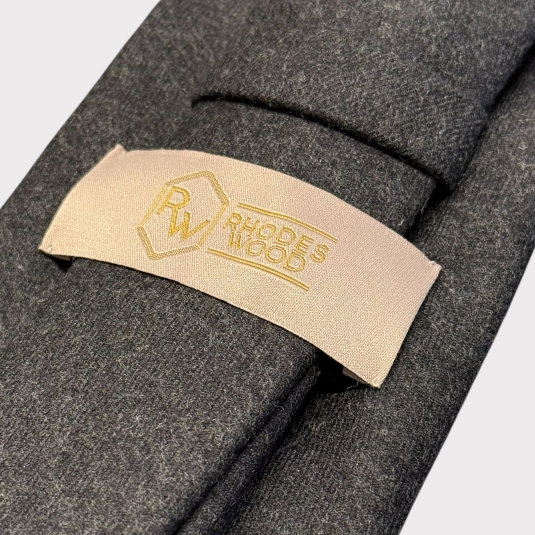 Close-up of a gray fabric with a beige label featuring 'Rhodes Wood' branding.