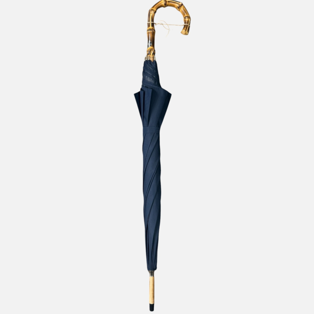A navy striped umbrella on a Wanghee handle 