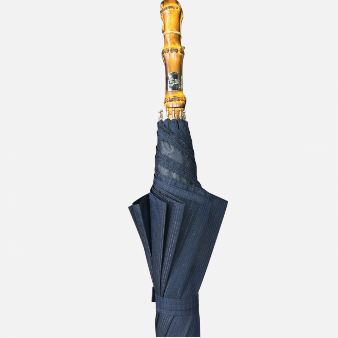 A navy striped umbrella on a Wanghee handle 