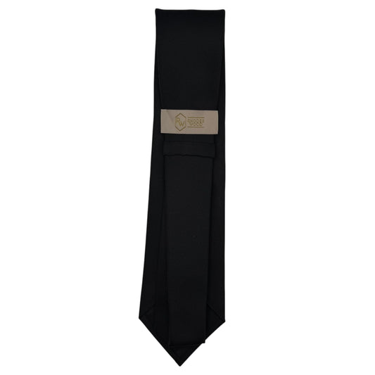 A black necktie with a beige woven label featuring a gold logo, displayed vertically against a plain white background.