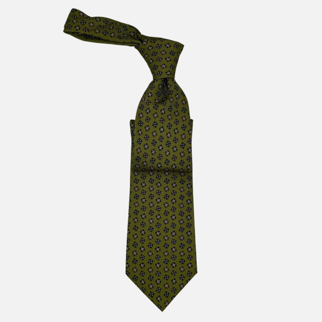 A moss coloured tie with medallions across the silk.