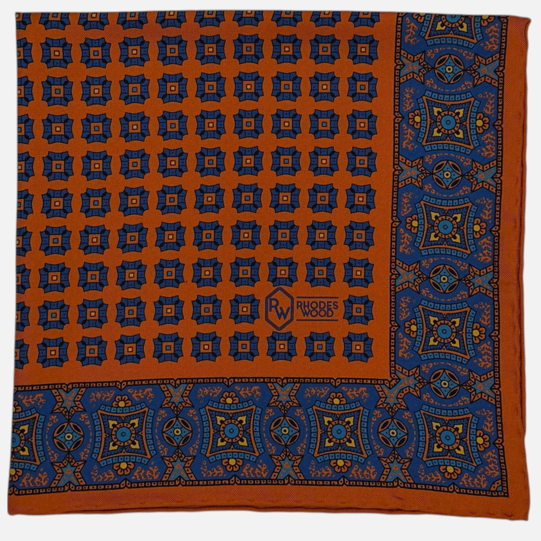 Orange & Blue pocket squares with blue mosaics repeating across the silk. 
