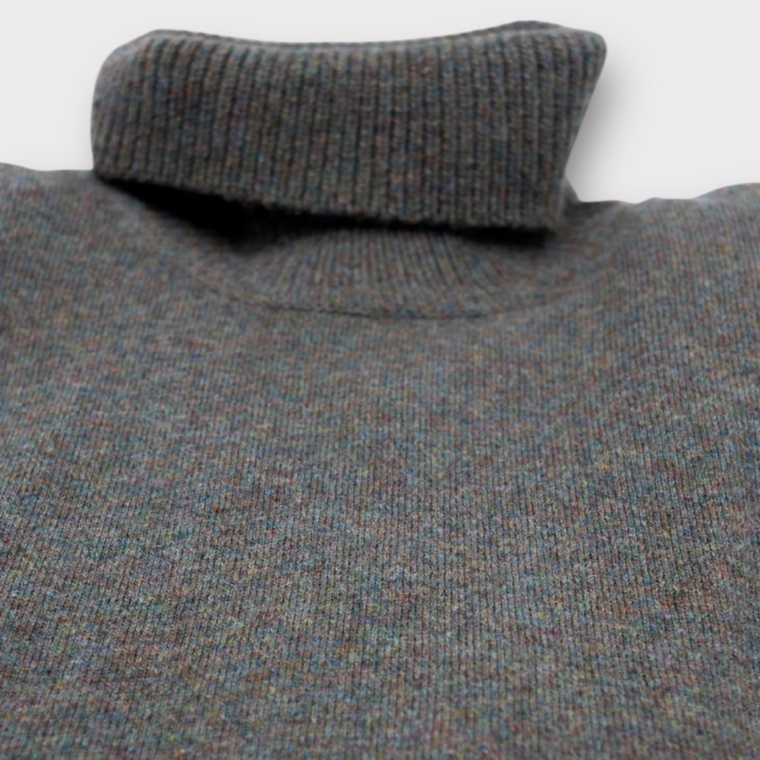 Close-up of a textured gray sweater with a white background