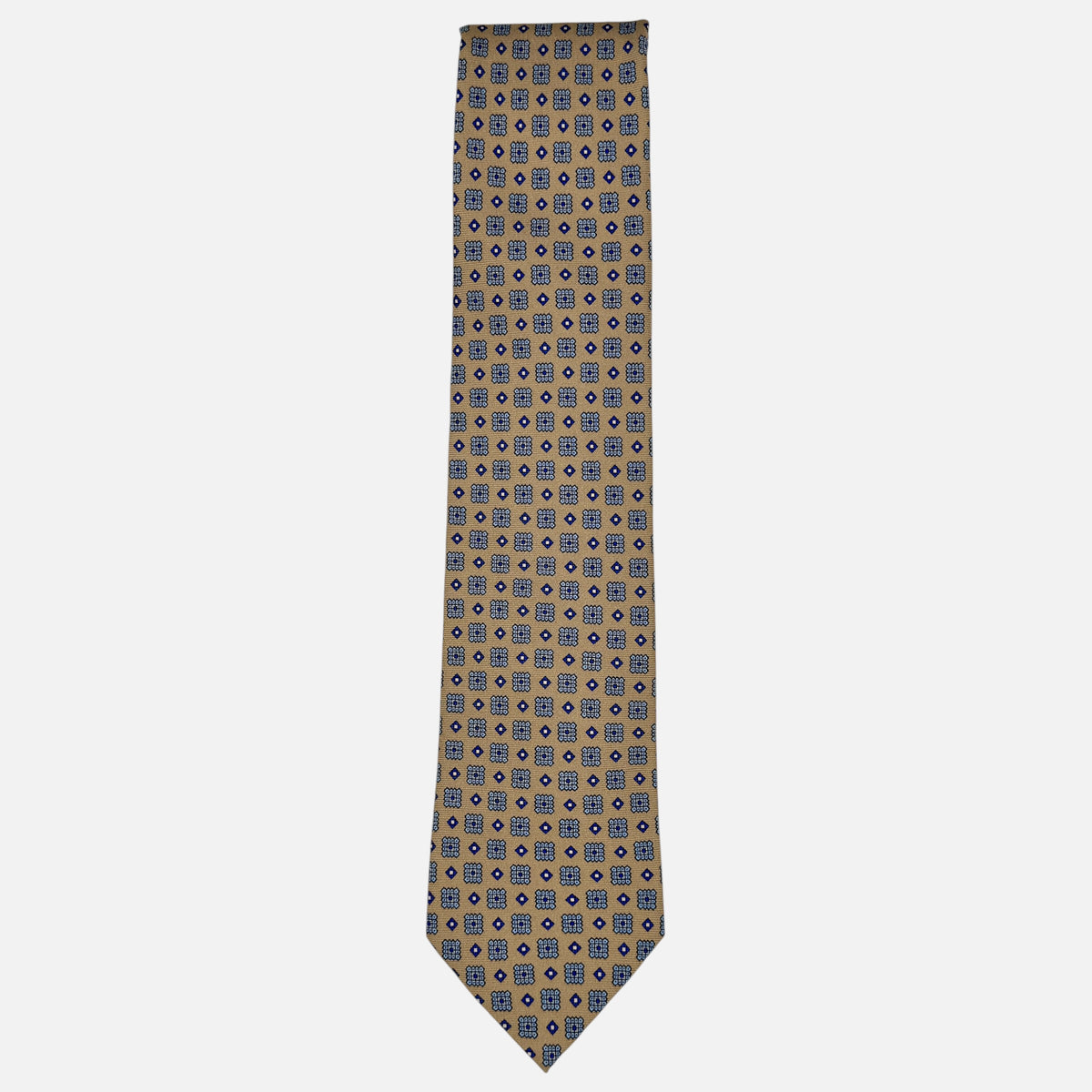 A camel base colour neck tie with navy medallions repeating. 