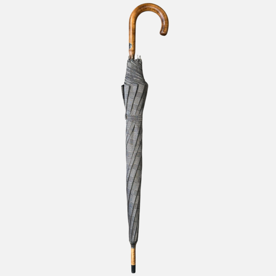 A beige check umbrella on a  malacca handle