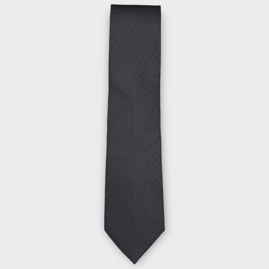 Classic silk necktie, printed in England, with a 9cm blade and 150cm length, laid flat against a plain background