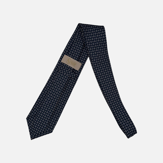 A navy necktie with miniature rosettes in a sky blue repeating. 