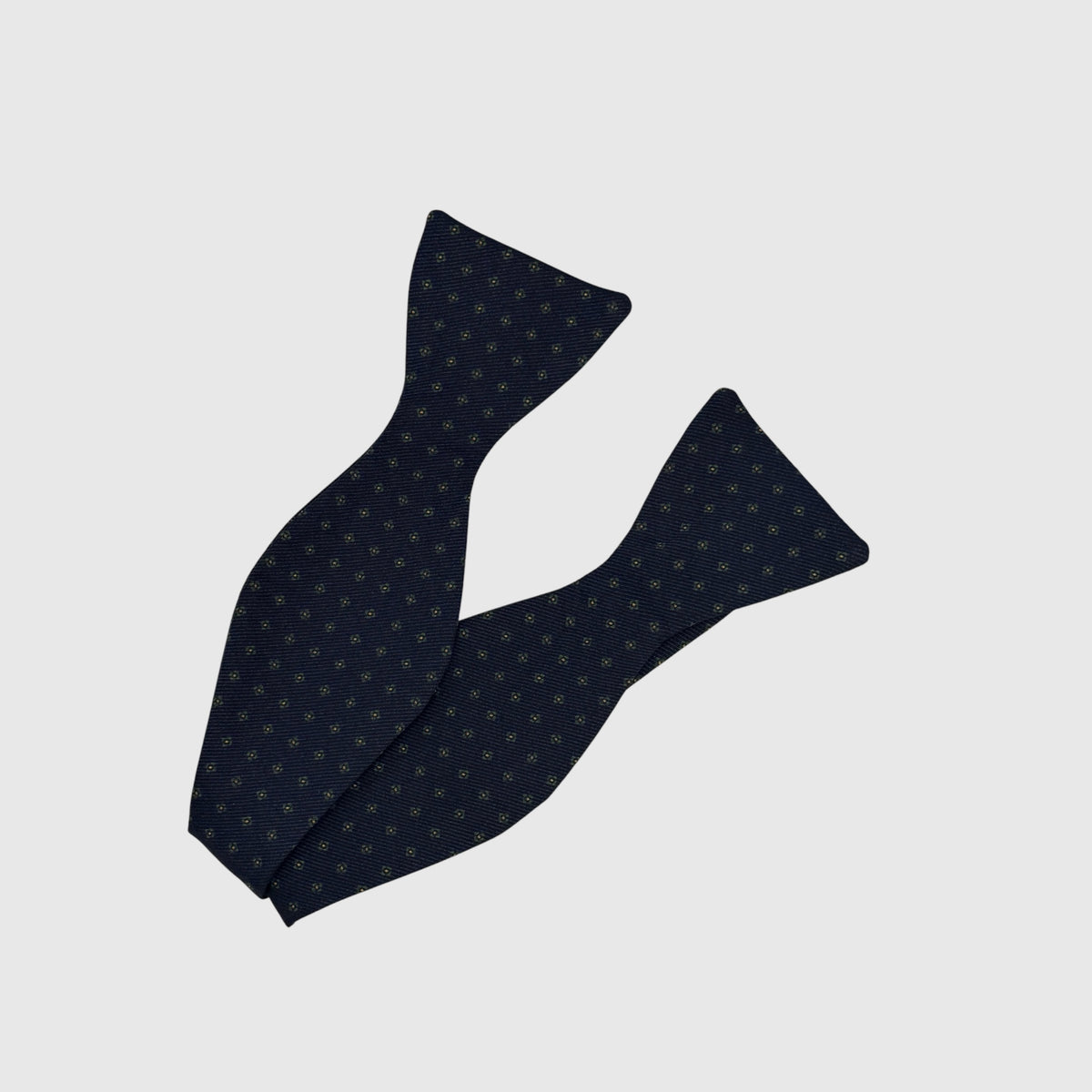 A self tie bow tie in a medallion print, navy bass colour green medallion 