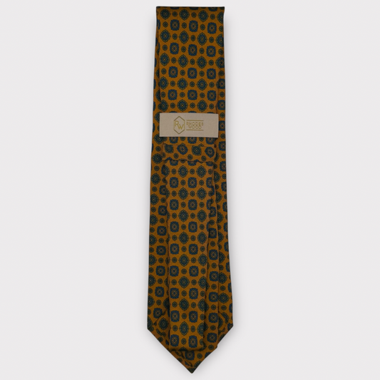 Classic silk necktie, printed in England, with a 9cm blade and 150cm length, laid flat against a plain background
