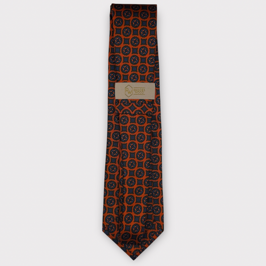 Classic silk necktie, printed in England, with a 9cm blade and 150cm length, laid flat against a plain background