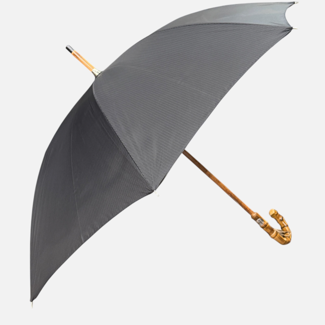 A black striped umbrella on a Wanghee handle 