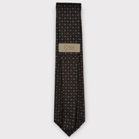 Classic silk necktie, printed in England, with a 9cm blade and 150cm length, laid flat against a plain background
