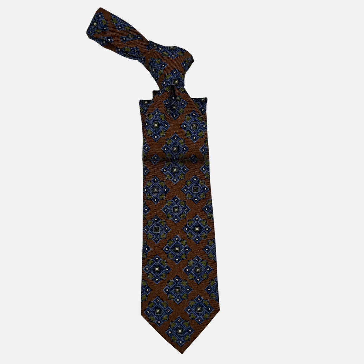 A Cognac neck tie with large blue and green medallion. 