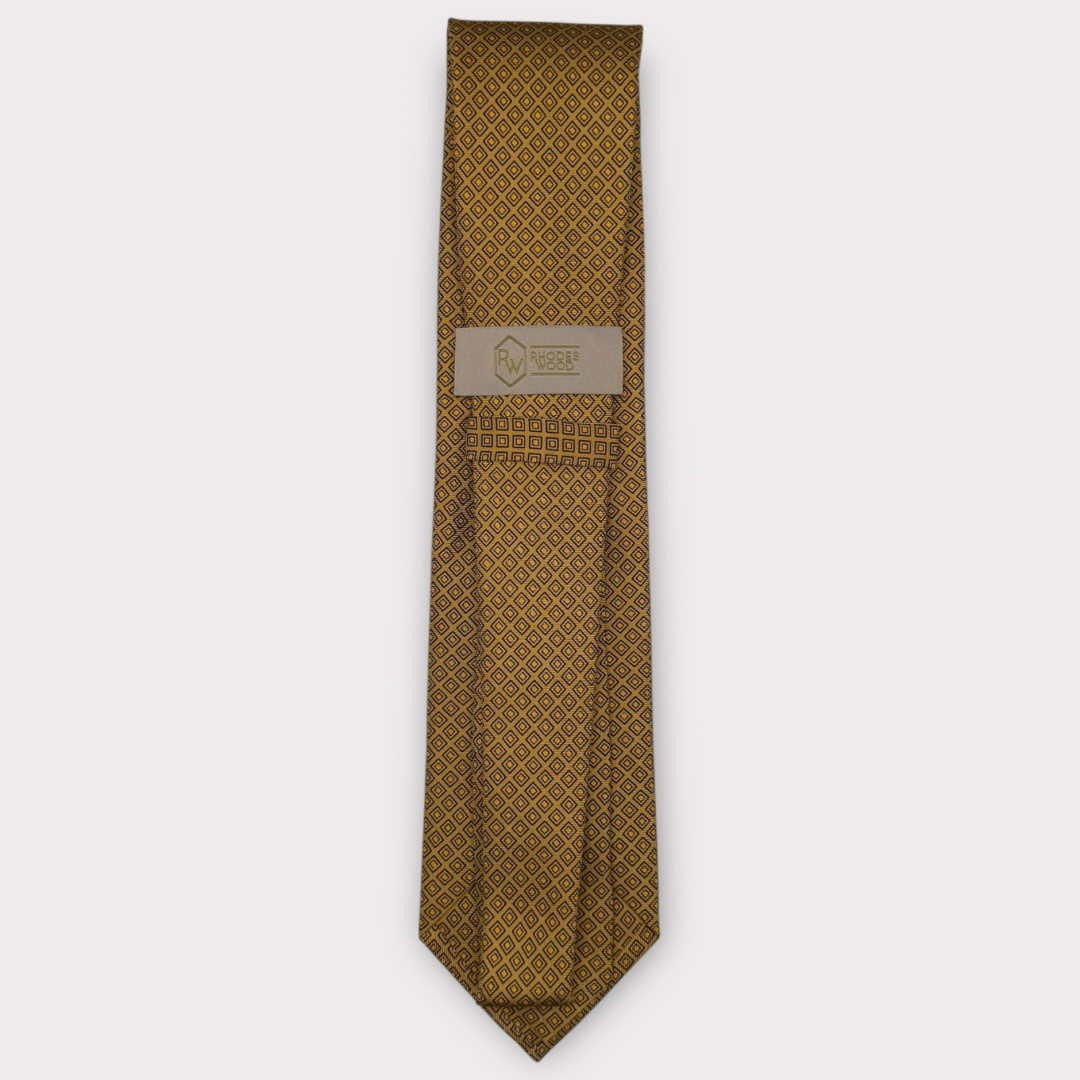 Classic silk necktie, printed in England, with a 9cm blade and 150cm length, laid flat against a plain background