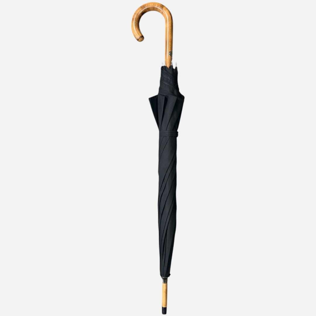 A black striped umbrella with a malacca handle 
