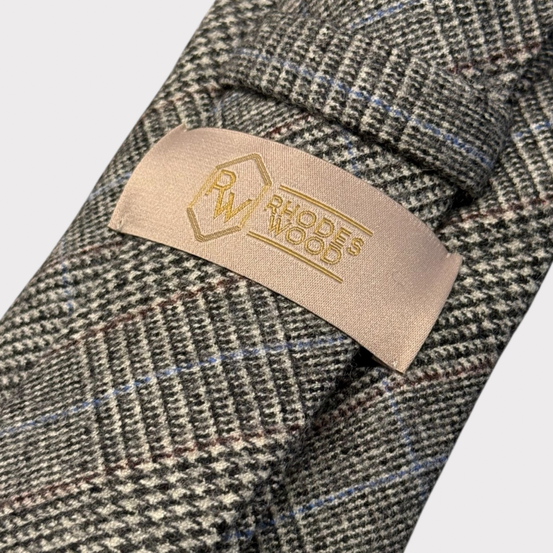 Close-up of a textured fabric with a visible brand label on a white background