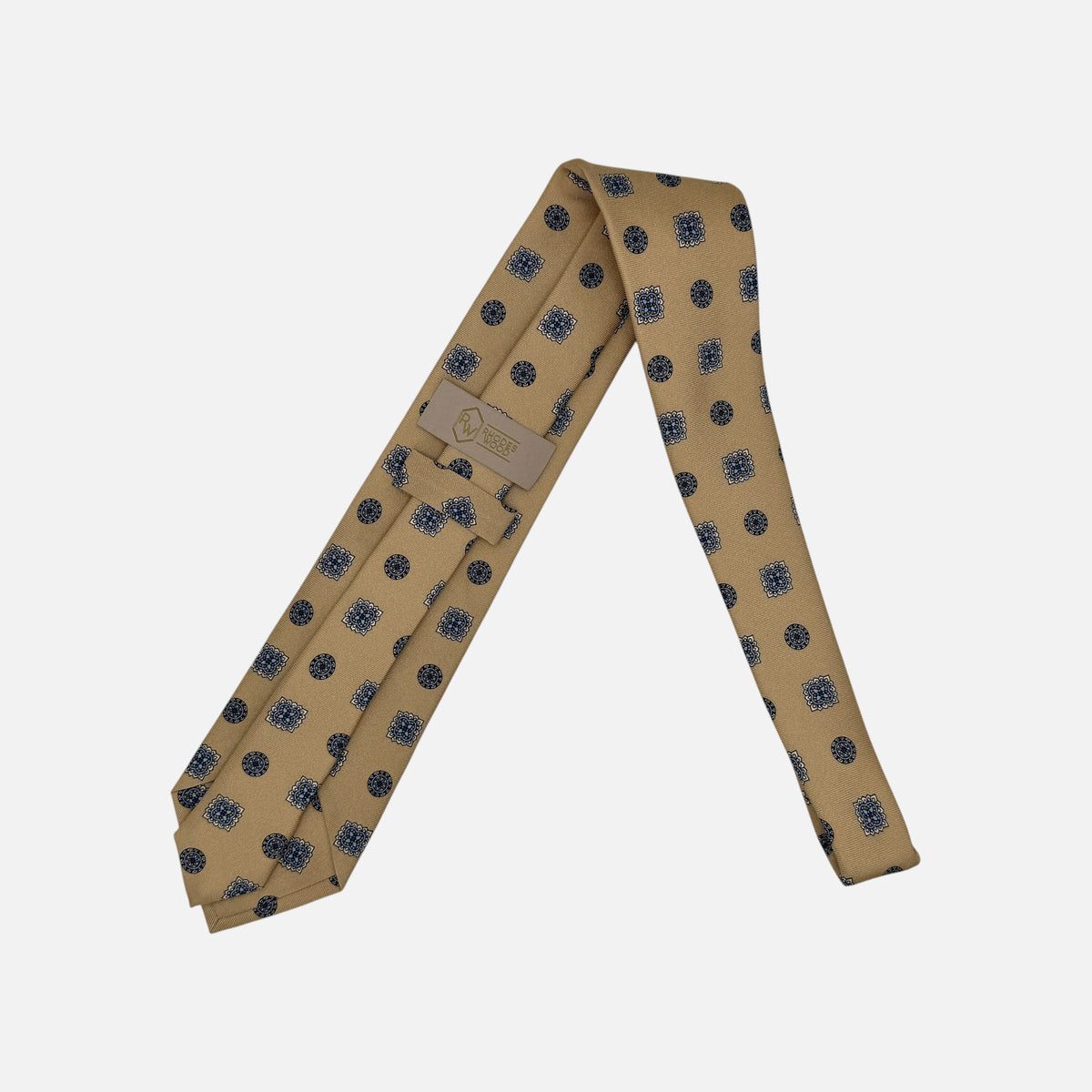 A camel coloured tie with light blue and navy large medallions.