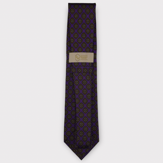 Classic silk necktie, printed in England, with a 9cm blade and 150cm length, laid flat against a plain background
