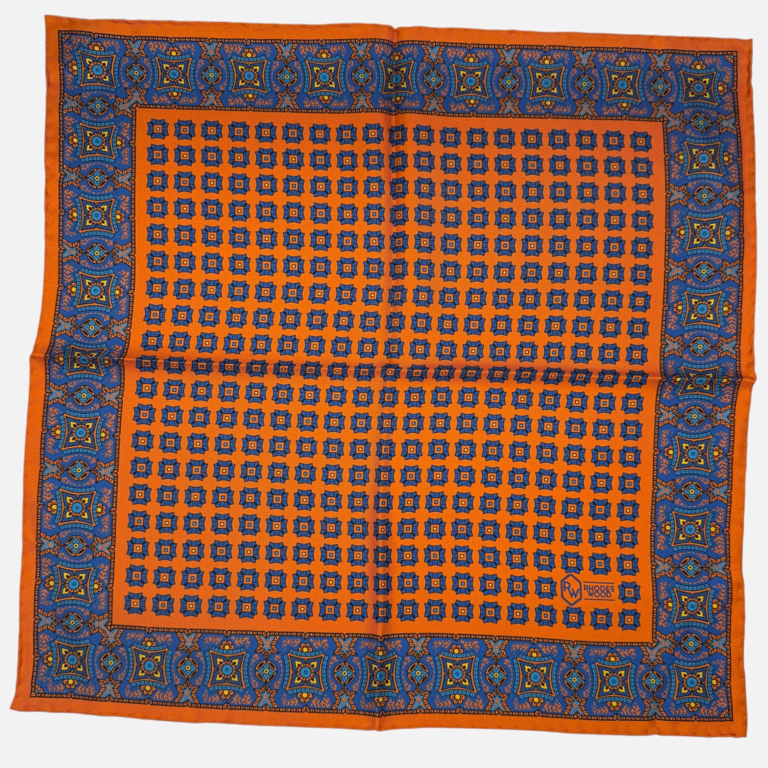Orange & Blue pocket squares with blue mosaics repeating across the silk. 