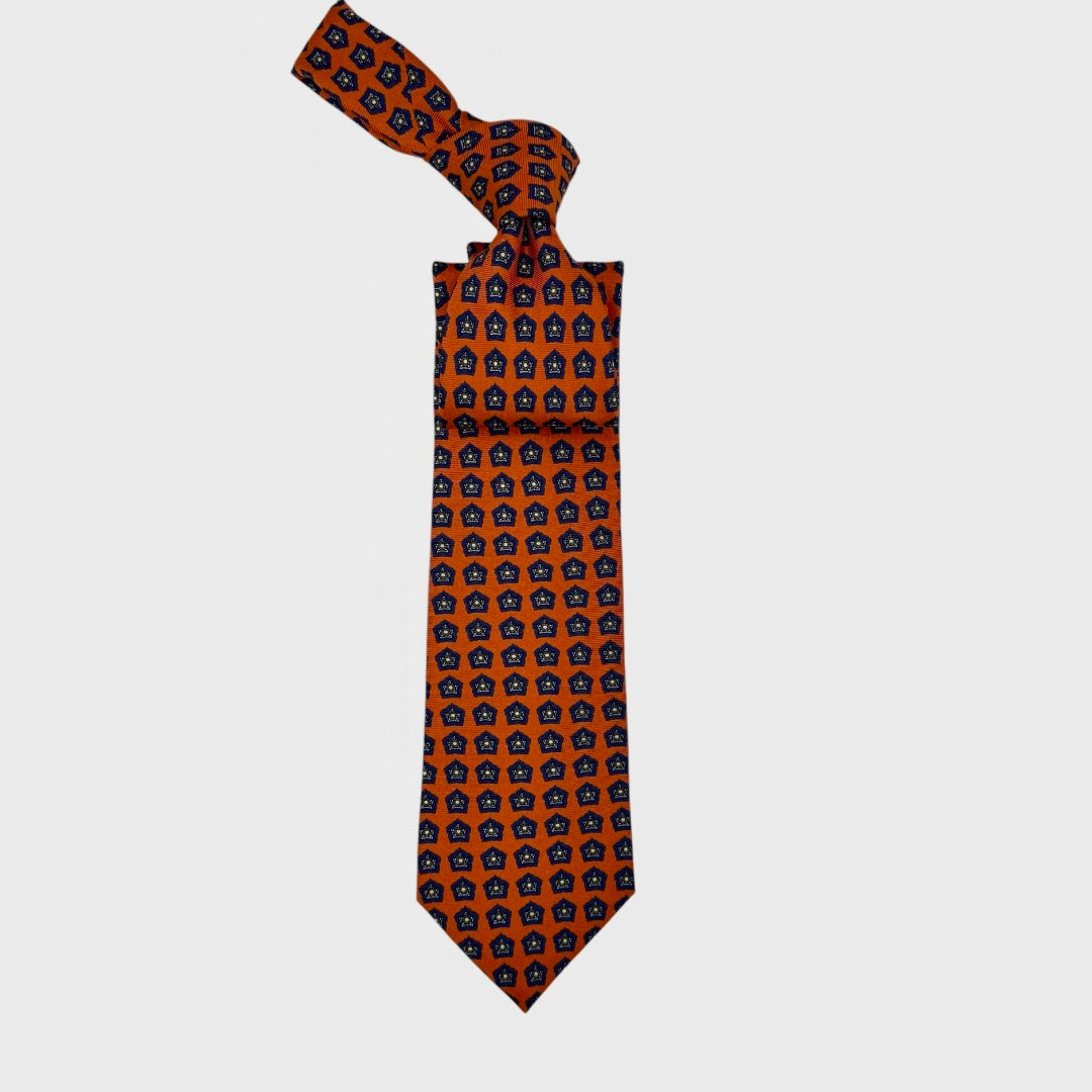 An orange neck tie with blue repeating star medallions. 