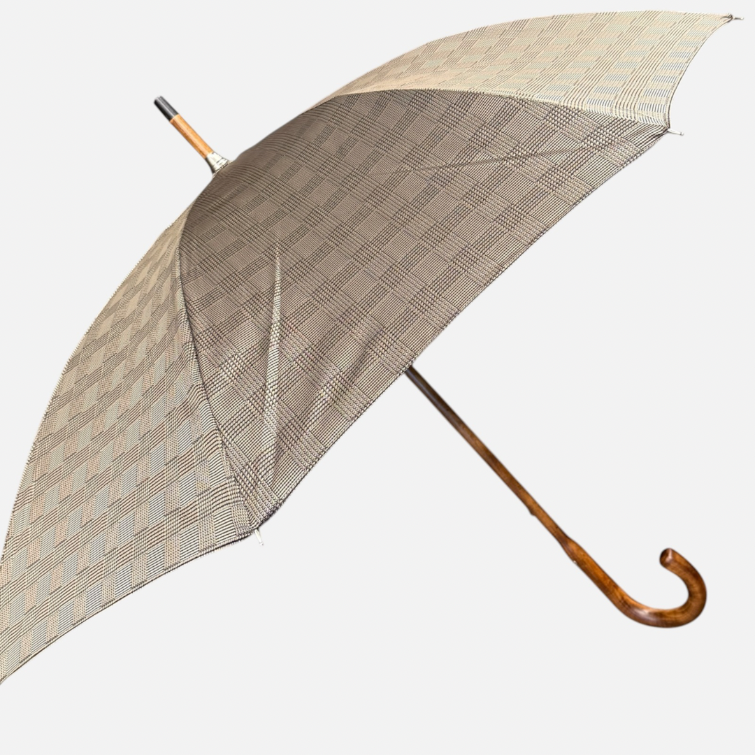 A beige check umbrella on a  malacca handle 