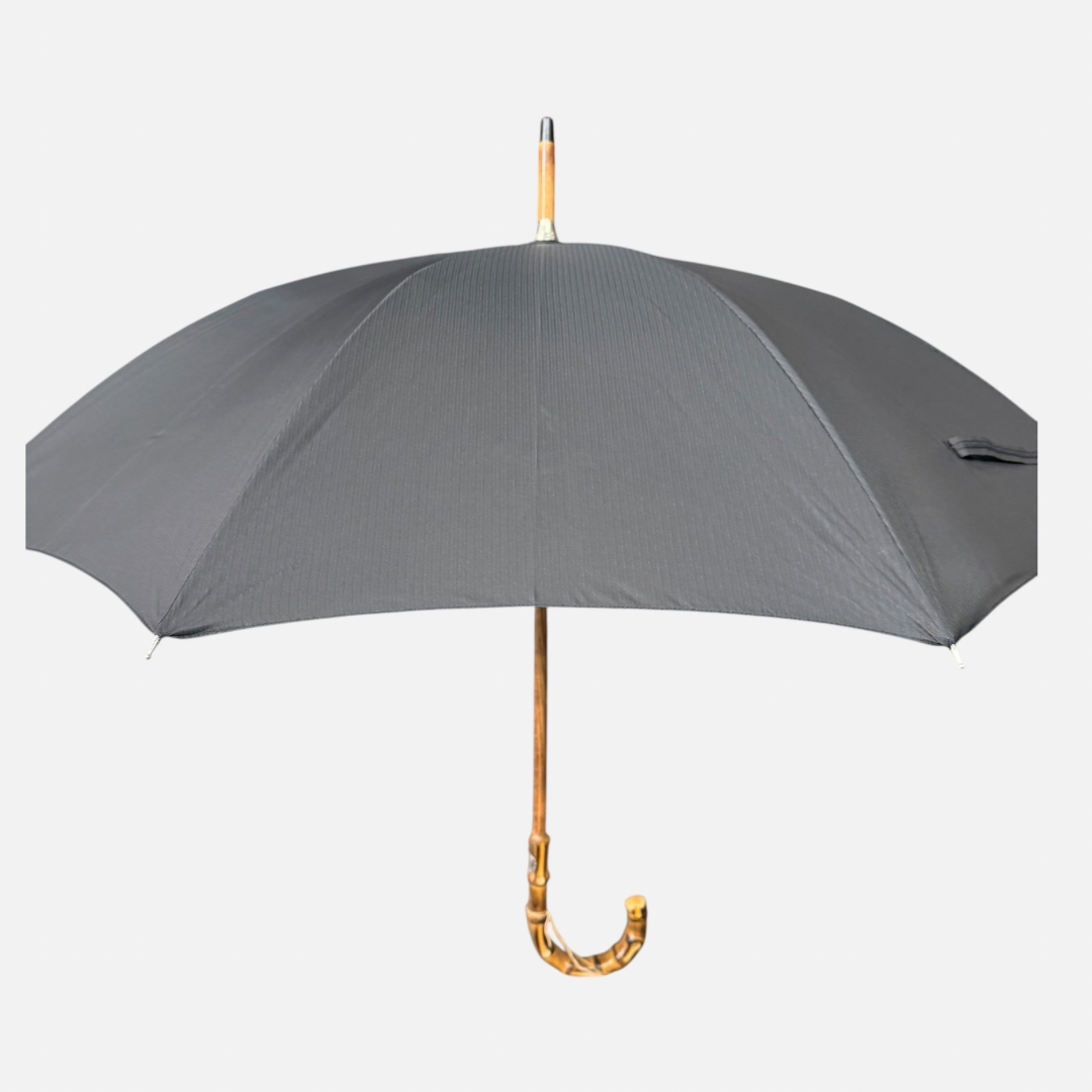 A black striped umbrella on a Wanghee handle