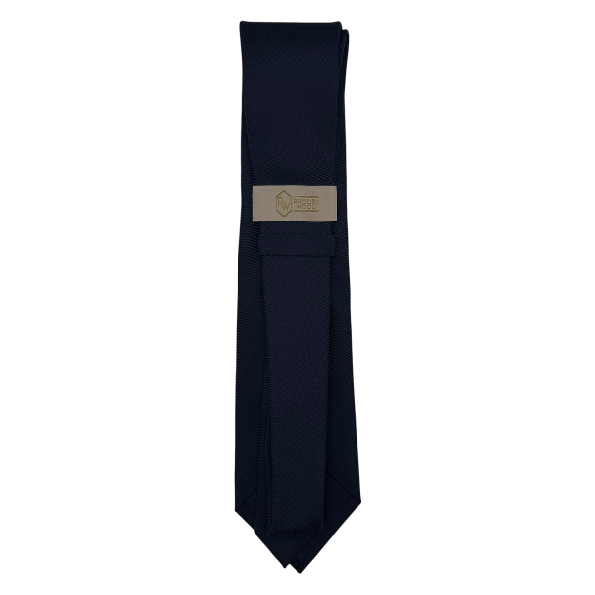 A dark navy blue necktie with a rectangular beige brand label in the center, displayed vertically against a plain white background.