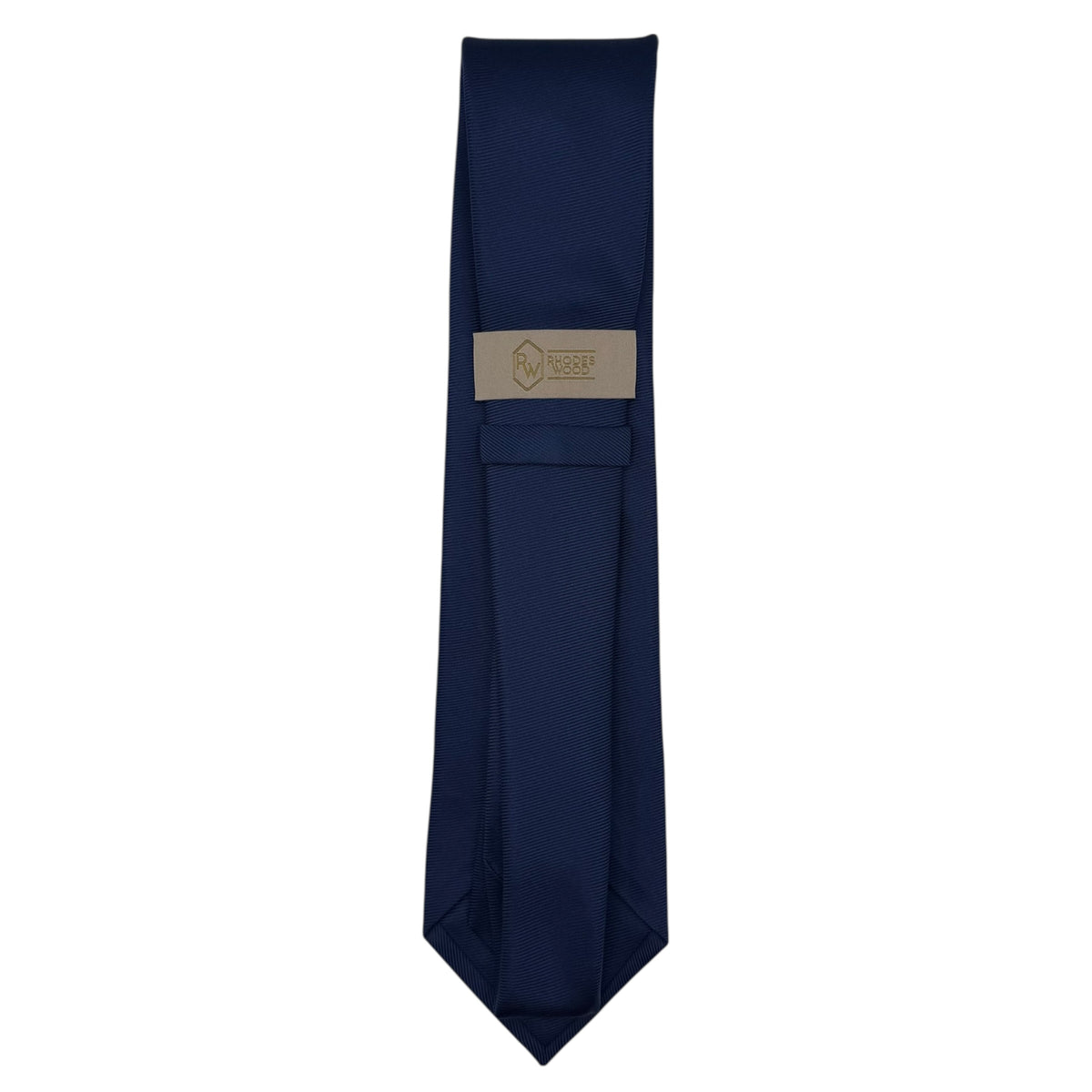 A  blue necktie with a beige woven label near the collar, displayed vertically against a plain white background.
