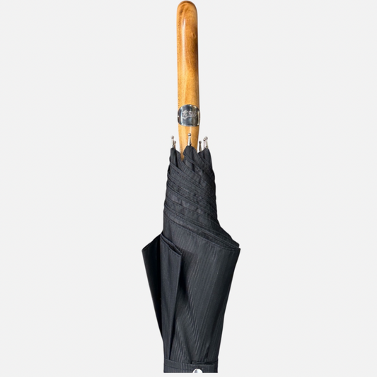A black striped umbrella with a malacca handle 