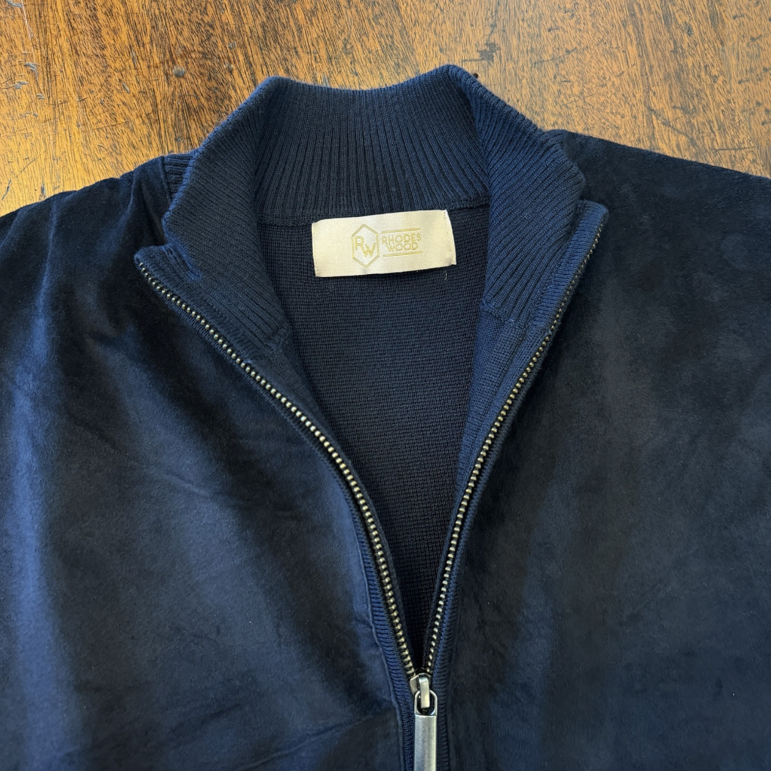 A Navy blue Suede front cardigan with knitted arms and back in Italian merino
Wool. 