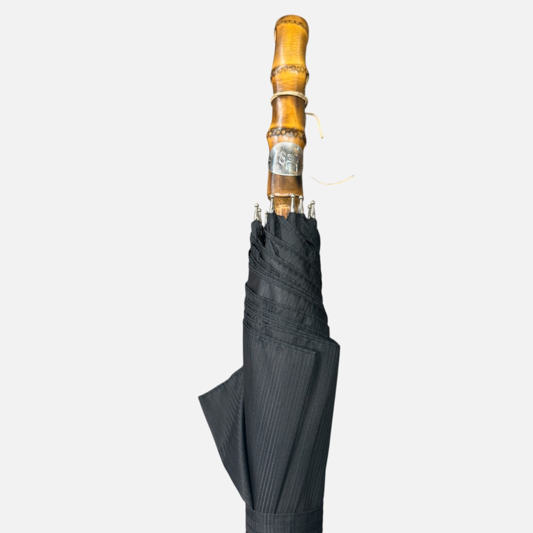 A black striped umbrella on a Wanghee handle