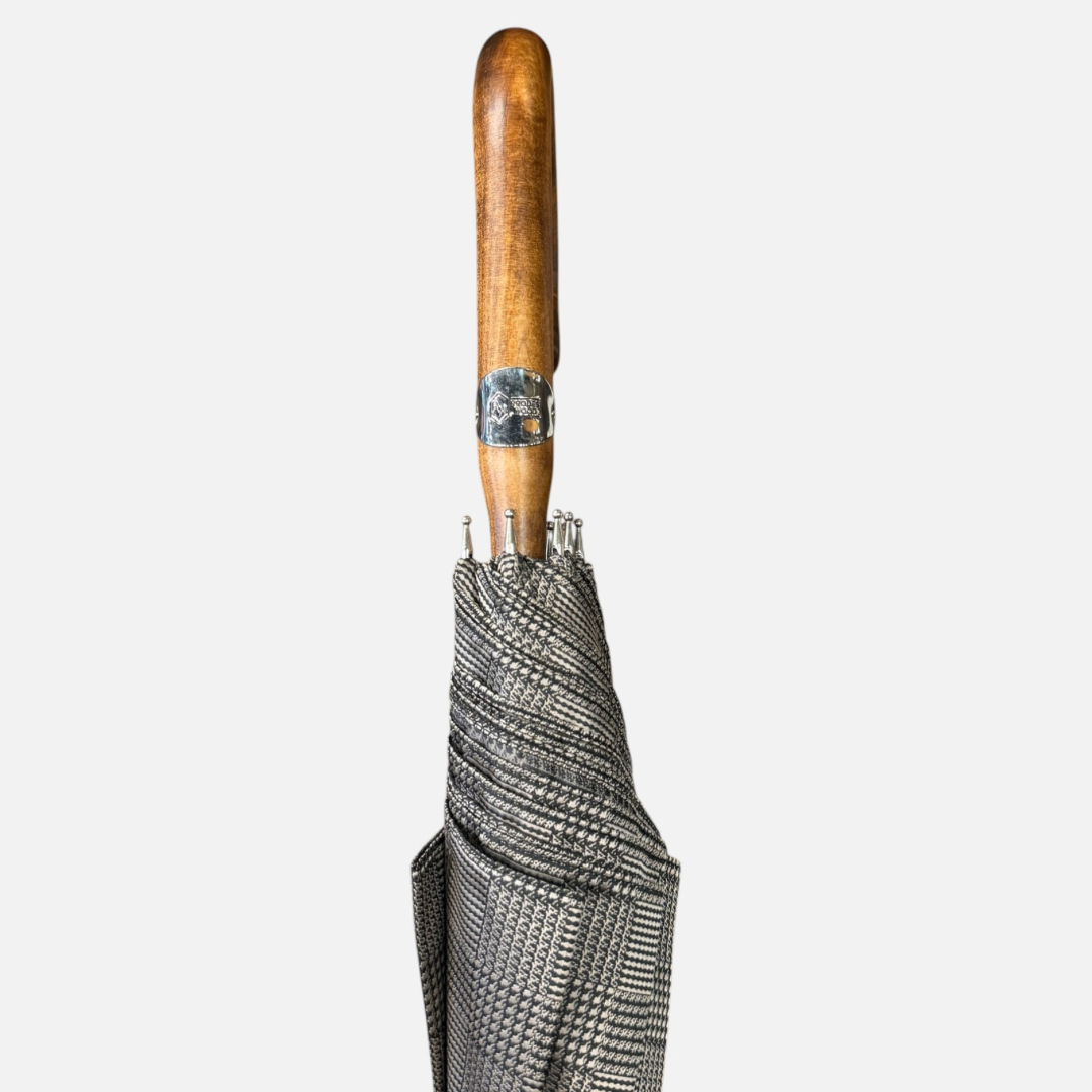 A beige check umbrella on a  malacca handle